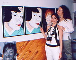 Colombe and Natasha posing in front of Colombe's portraits in the artist's studio, Montreal July 04