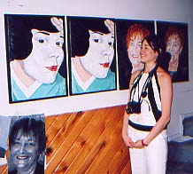 Colombe posing in front of her portraits in the artist's studio, Montreal July 04.