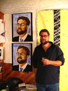 Jock in front of his portraits
